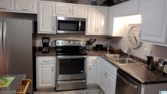 kitchen featuring appliances with stainless steel finishes, sink, and white cabinets