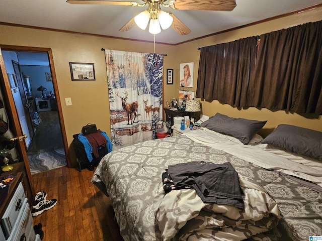 bedroom featuring ceiling fan, ornamental molding, and dark hardwood / wood-style floors