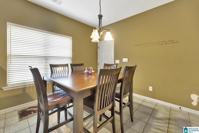 dining space with a notable chandelier and light tile patterned floors