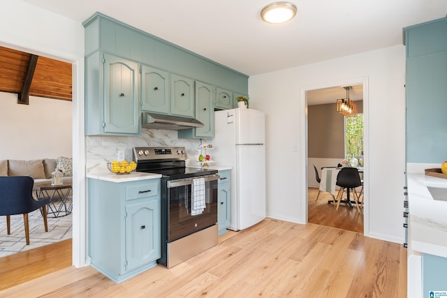 kitchen with stainless steel range with electric cooktop, decorative light fixtures, light wood-type flooring, white refrigerator, and backsplash