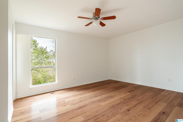 unfurnished room with light hardwood / wood-style flooring and ceiling fan