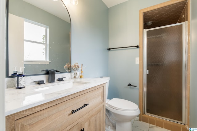 bathroom featuring vanity, an enclosed shower, and toilet