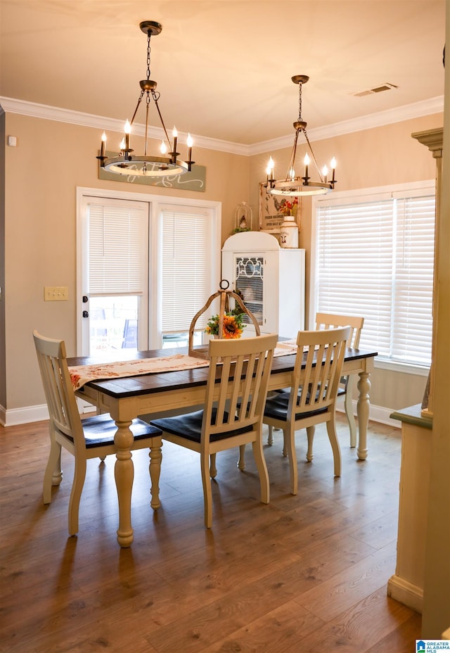 dining area featuring crown molding and hardwood / wood-style floors