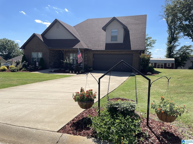 view of front of property featuring a garage and a front lawn