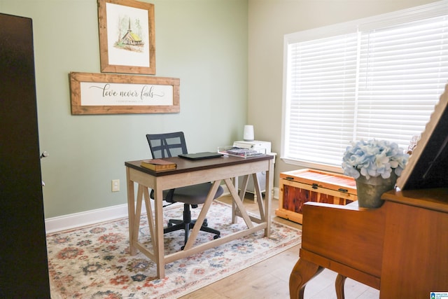 office area with light hardwood / wood-style floors