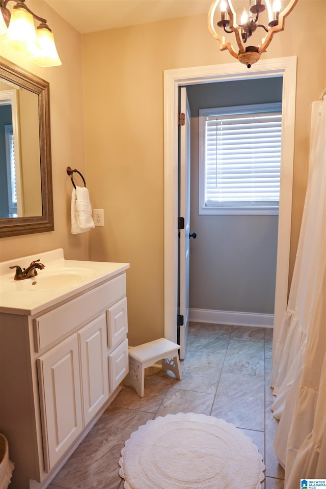 bathroom with vanity and a notable chandelier