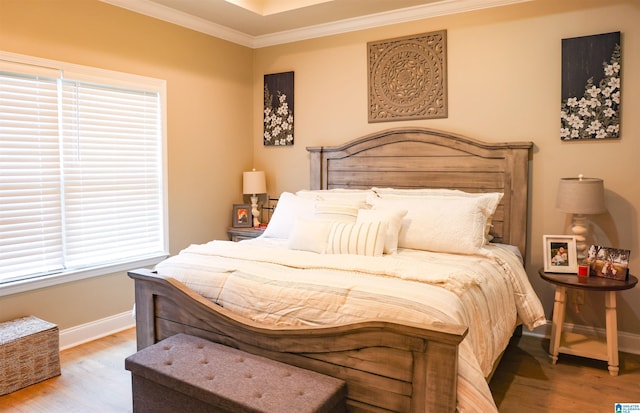 bedroom featuring hardwood / wood-style flooring and crown molding