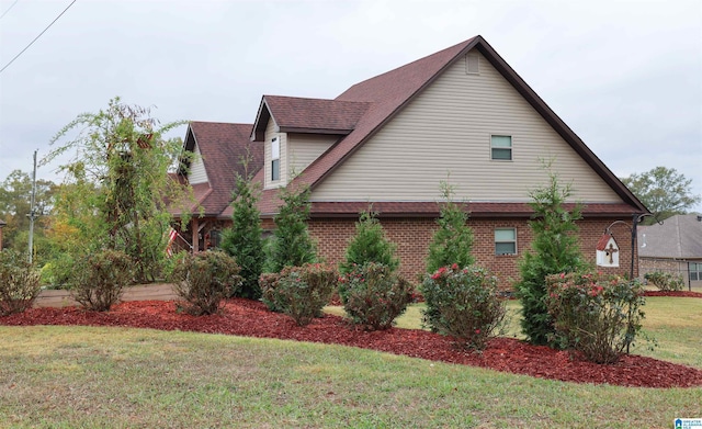 view of side of home featuring a lawn