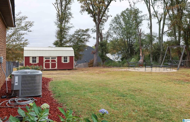 view of yard with a shed, a patio, and central air condition unit