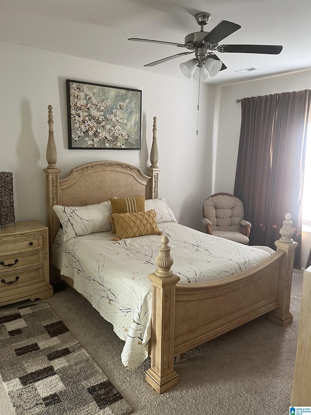 bedroom featuring ceiling fan and dark carpet