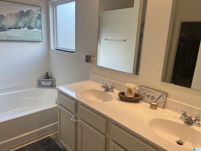 bathroom featuring a tub to relax in and vanity