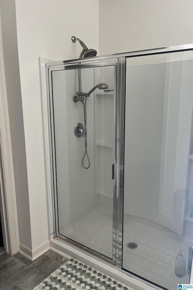 bathroom with a shower with door