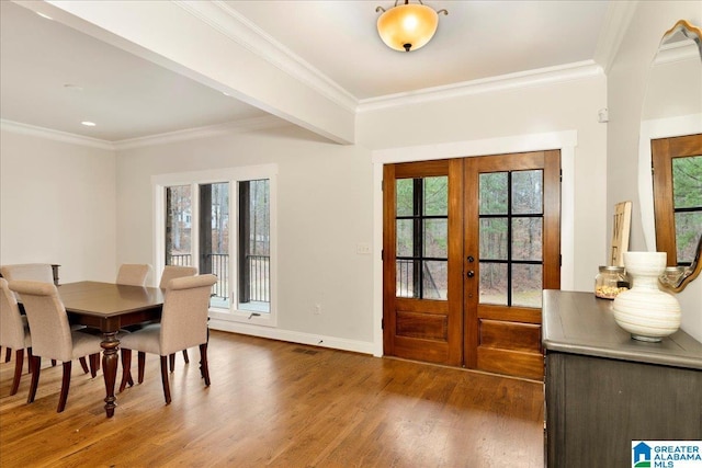 interior space with dark wood-type flooring, ornamental molding, and french doors