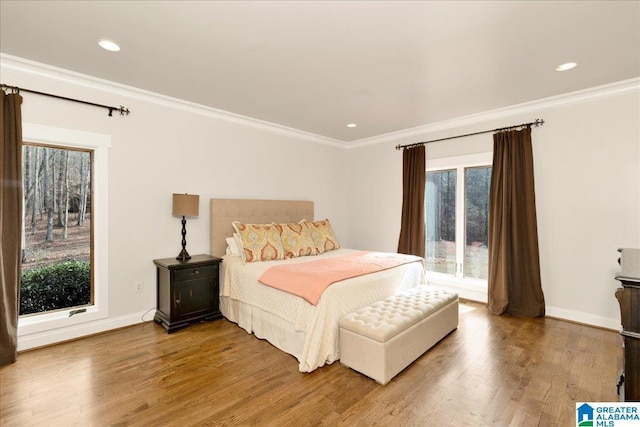 bedroom with crown molding and wood-type flooring