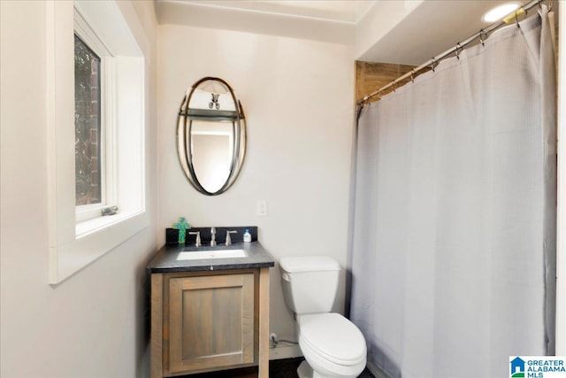 bathroom featuring vanity, a shower with curtain, and toilet