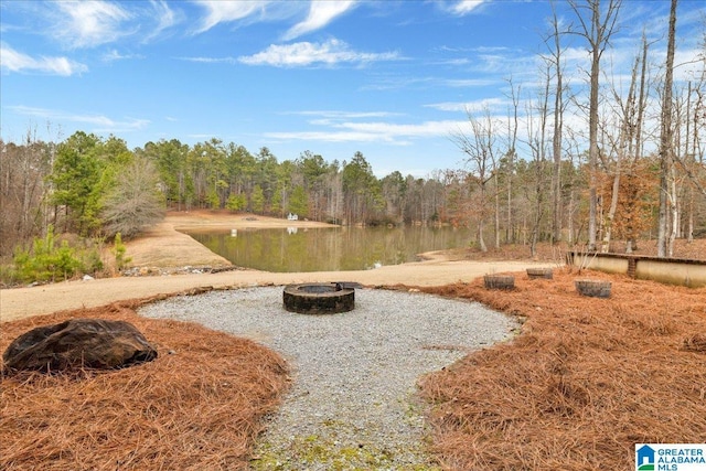 view of yard featuring a fire pit and a water view