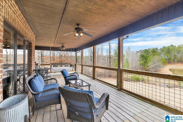 sunroom featuring ceiling fan