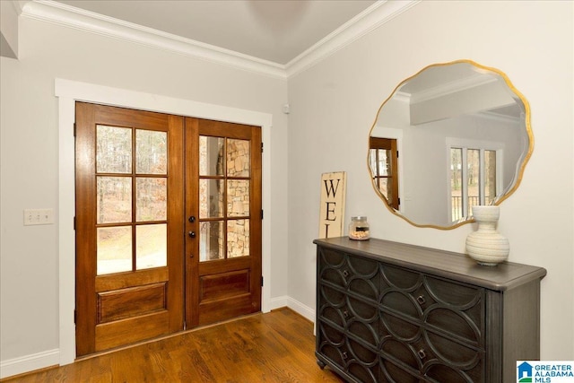 entryway with dark hardwood / wood-style flooring, ornamental molding, and french doors