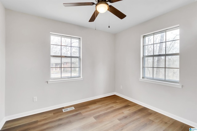 unfurnished room with ceiling fan, plenty of natural light, and light hardwood / wood-style flooring