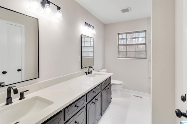 bathroom featuring tile patterned floors, vanity, and toilet