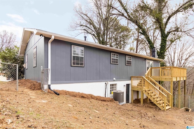 back of property featuring cooling unit and a deck