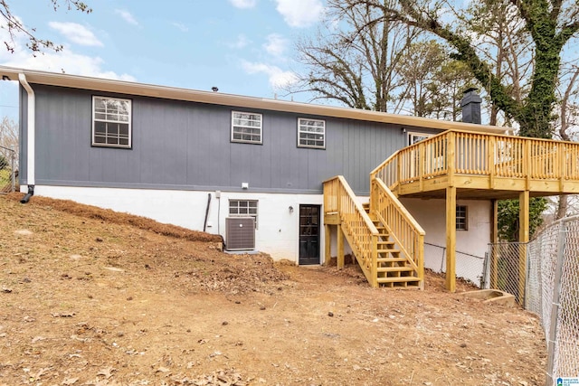 rear view of house with cooling unit and a deck