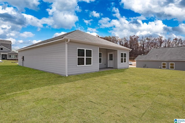 back of property featuring a lawn and a patio area