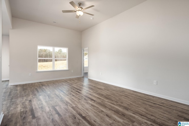 unfurnished room with dark hardwood / wood-style floors and ceiling fan