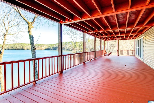 wooden terrace featuring a water view