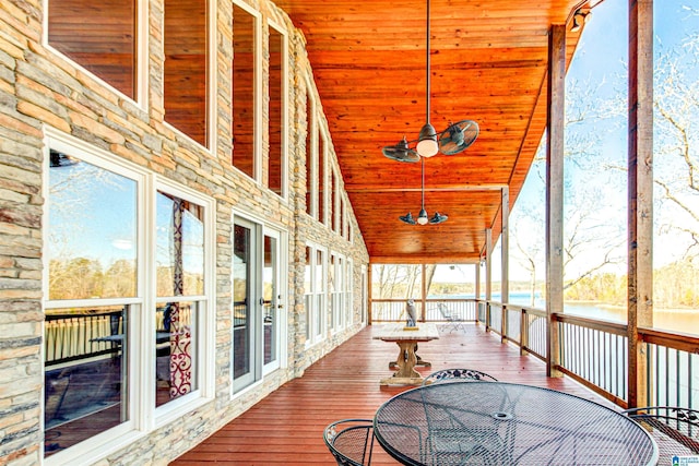 sunroom / solarium with ceiling fan, lofted ceiling, and wooden ceiling