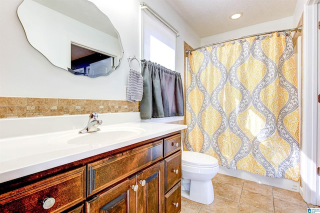 bathroom featuring vanity, tile patterned floors, a textured ceiling, and toilet