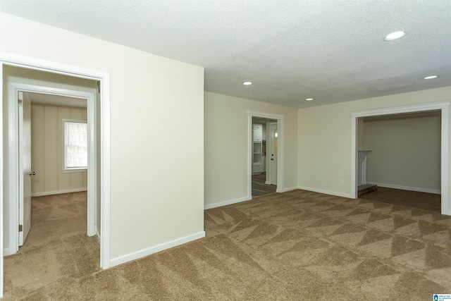 unfurnished bedroom featuring carpet and a textured ceiling