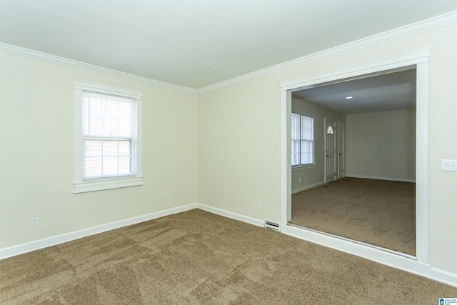 carpeted empty room featuring crown molding