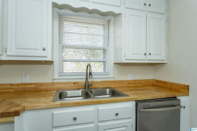 kitchen featuring white cabinetry, wood counters, dishwasher, and sink
