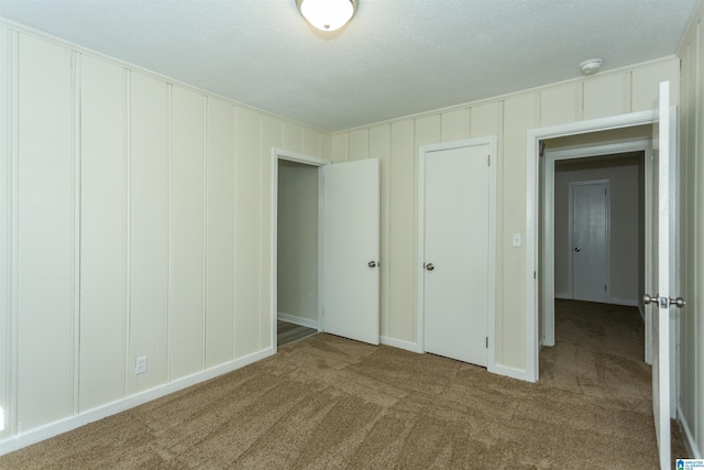 unfurnished bedroom with carpet flooring and a textured ceiling