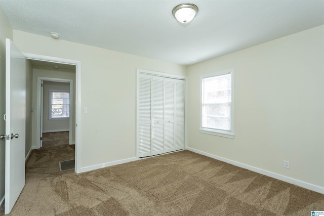 unfurnished bedroom featuring a closet and carpet