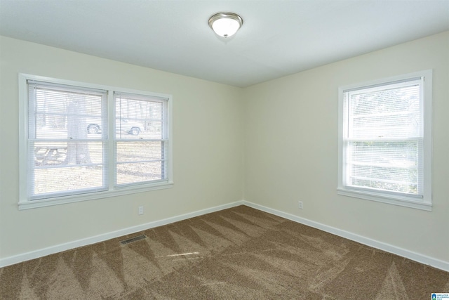 unfurnished room featuring carpet