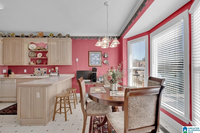 dining area featuring sink and a chandelier