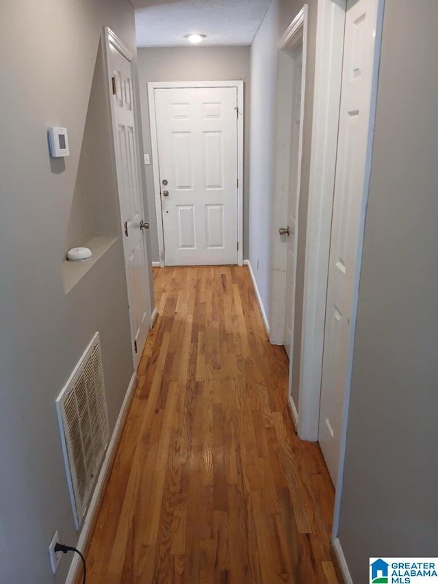 corridor featuring light hardwood / wood-style floors