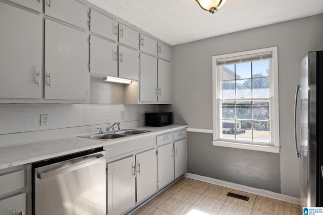 kitchen with white cabinetry, appliances with stainless steel finishes, sink, and plenty of natural light