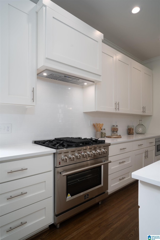 kitchen featuring stainless steel stove, white cabinets, dark hardwood / wood-style flooring, backsplash, and custom exhaust hood