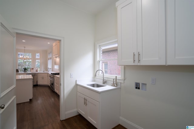 kitchen with stainless steel appliances, a wealth of natural light, sink, and white cabinets