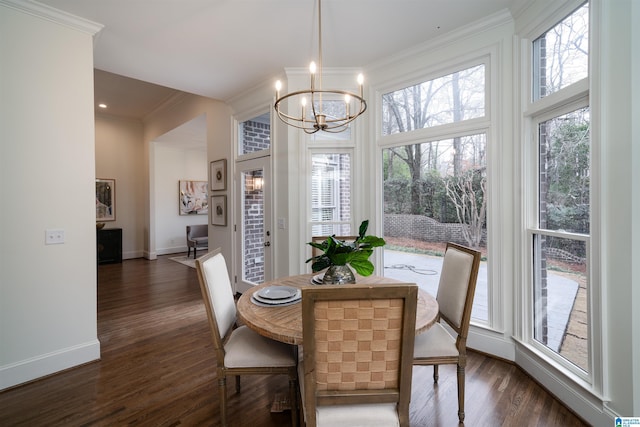 dining area with crown molding, an inviting chandelier, and dark wood-type flooring