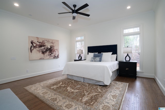 bedroom featuring multiple windows, crown molding, and dark hardwood / wood-style floors