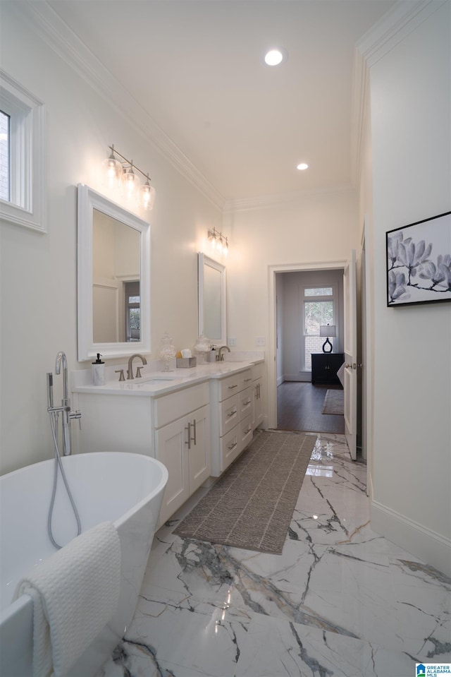 bathroom with ornamental molding, a bath, and vanity