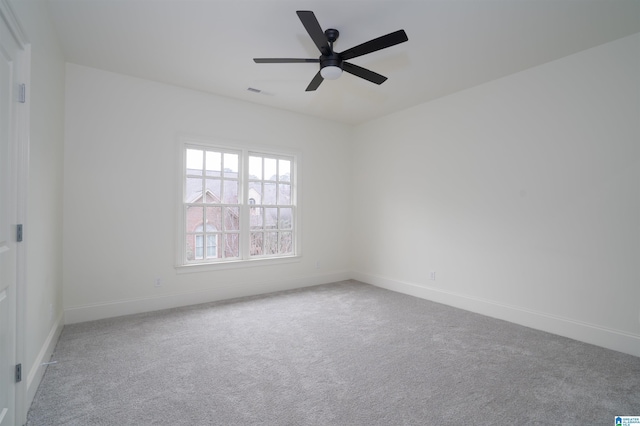 carpeted spare room featuring ceiling fan