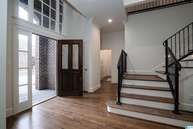 entryway featuring ornamental molding and hardwood / wood-style floors