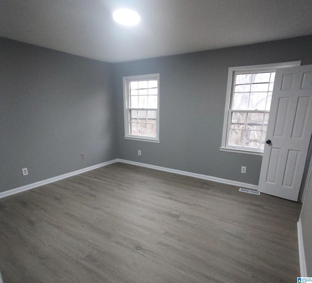 empty room with dark hardwood / wood-style floors