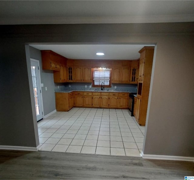 kitchen featuring light tile patterned flooring and sink