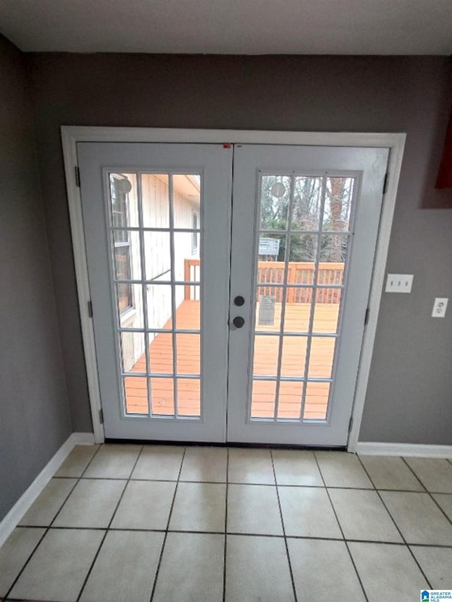 doorway with light tile patterned floors and french doors